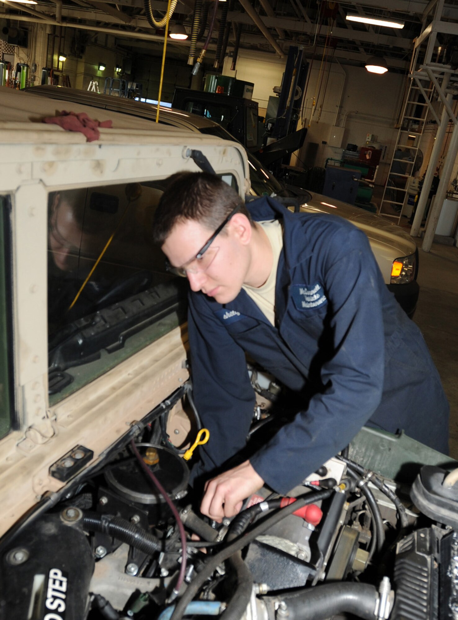 Airman 1st Class Brandyn Shelly, 22nd Logistics Readiness Squadron vehicle maintenance apprentice, installs an injection pump on a humvee Dec. 15, 2011, McConnell Air Force Base, Kan.  Shelly is responsible for performing preventative and special maintenance, inspections, troubleshooting, rebuilding and adjusting components and assemblies pertaining to vehicles on McConnell.