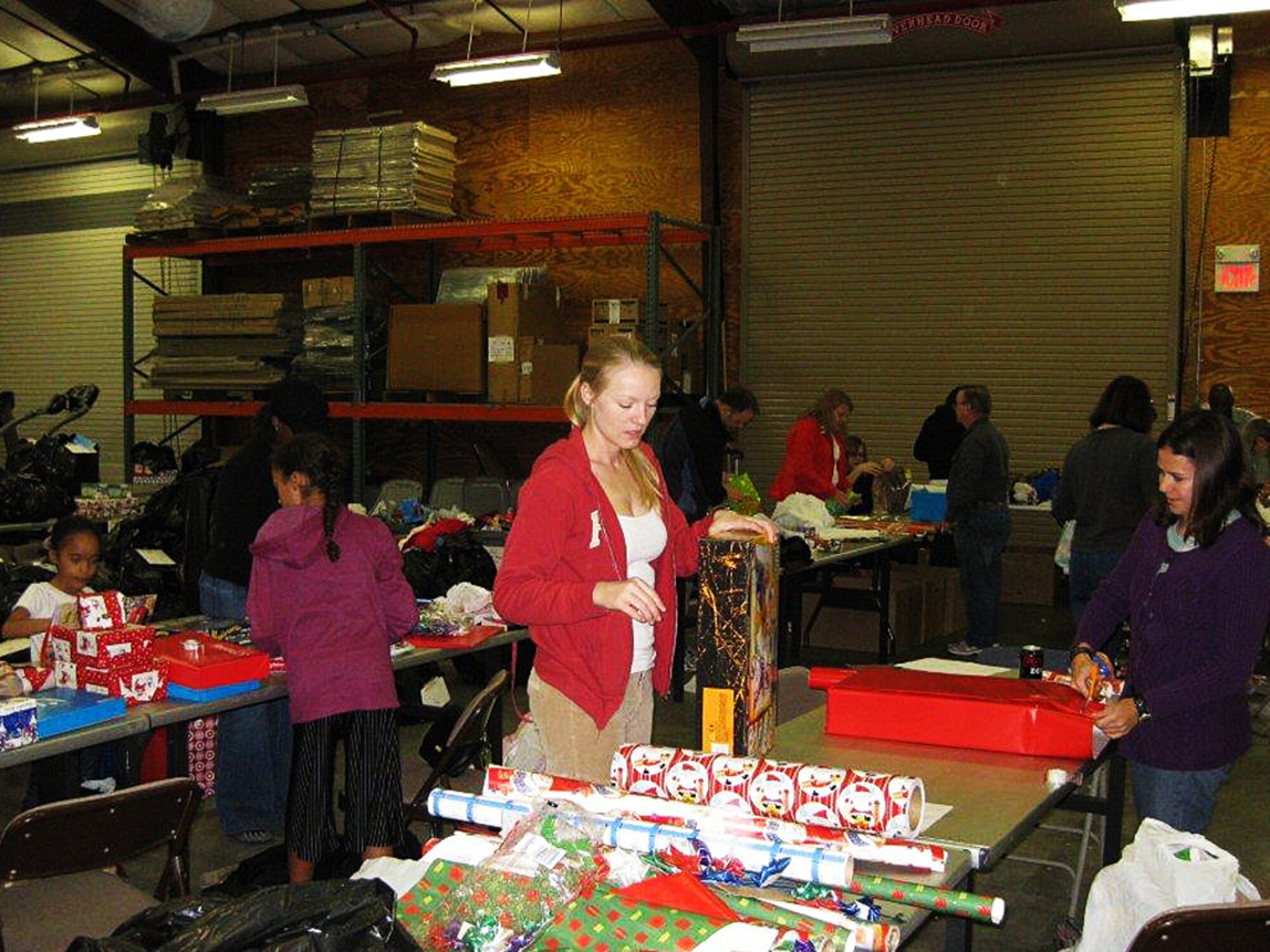 Volunteers for the Angel Tree program help wrap and organize gifts for military family children on Hurlburt Field, Fla. Dec. 12, 2011. More than 40 volunteers came to help and sponsor families. (Courtesy photo)