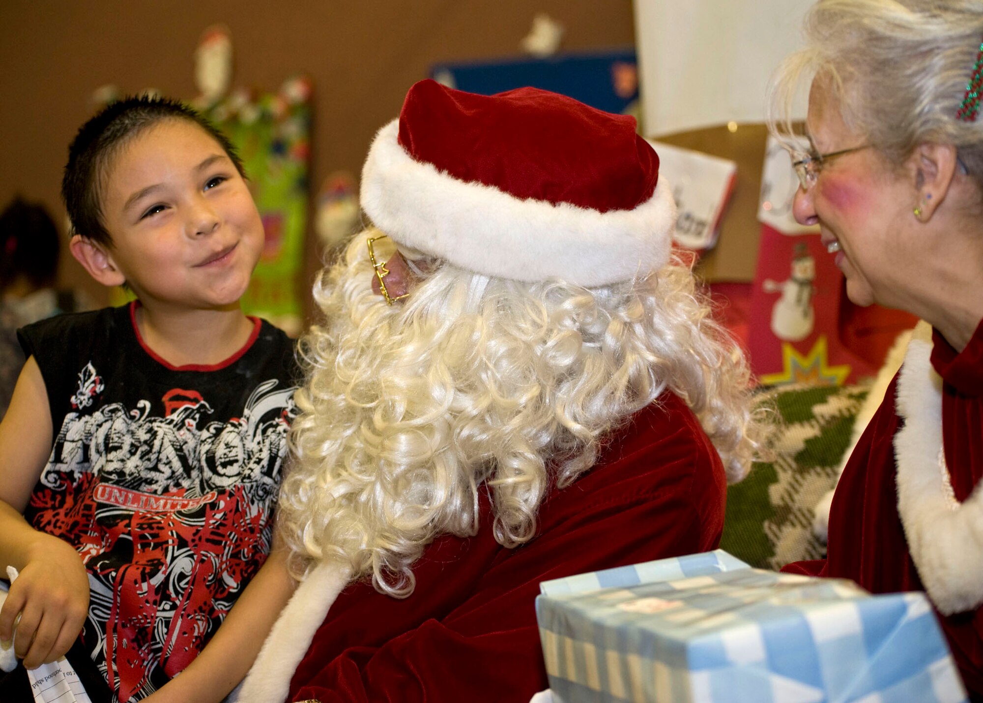 David Anungazuk, 7, visits with Santa and Mrs. Claus, in Wales, Dec. 9. The Clauses along with about 35 volunteers from Anchorage were in the Wales for an Operation Santa mission.   (National Guard photo/MSgt. Shannon Oleson)

