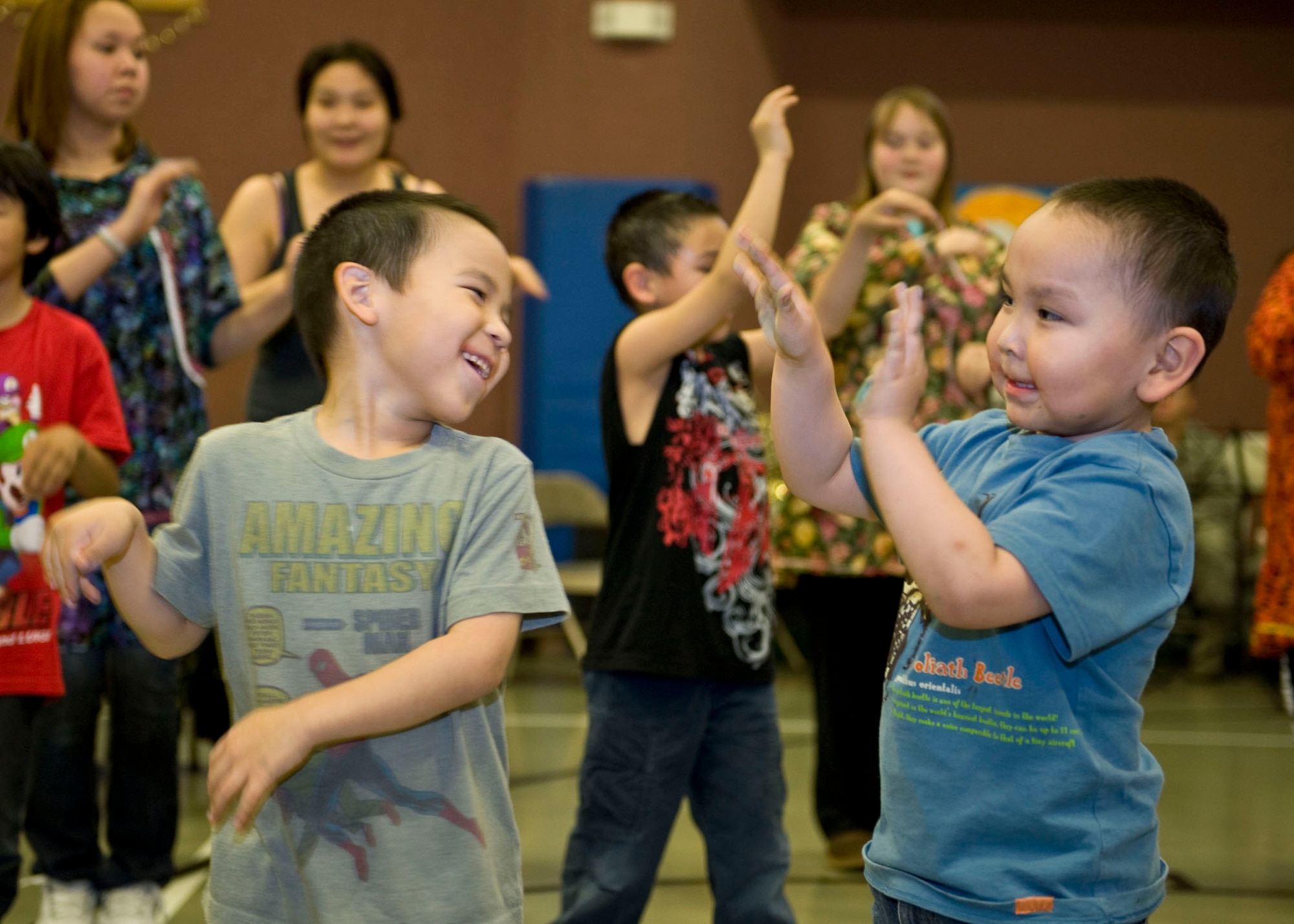 Lucien Ongtowasruk and Kayden Komonaseak, both 5-years-old from Wales,
perform the igloo dance during the Alaska National Guard Operation Santa
Claus visit Dec. 9.  (National Guard photo/MSgt. Shannon Oleson)
