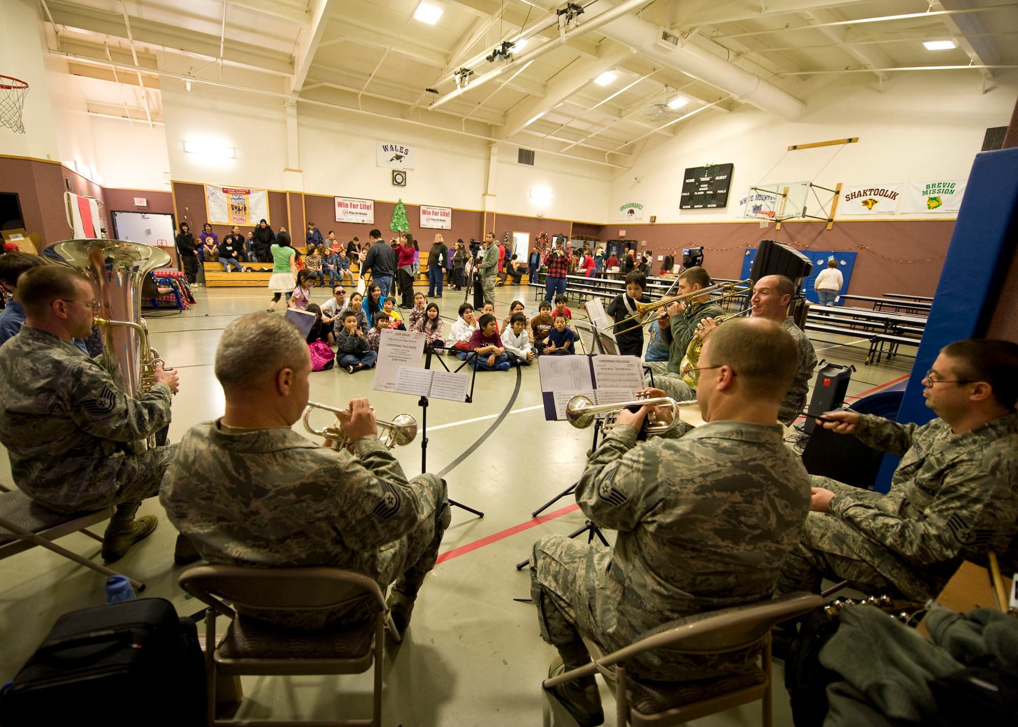 Members of Alaska Brass, a brass and percussion ensemble from the U.S. Air Force Band of the Pacific play holiday music for an Operation Santa Claus mission, Dec. 9. About 35 volunteers from Anchorage participated in the mission. The aircraft along with about 35 volunteers from Anchorage, Alaska were in Wales for an Operation Santa Claus mission. Op Santa has been a tradition for the Alaska National Guard since 1956. Each year, it brings Santa, Mrs. Claus, along with gifts to some of the small, remote villages of Alaska.  (National Guard photo/MSgt. Shannon Oleson)
