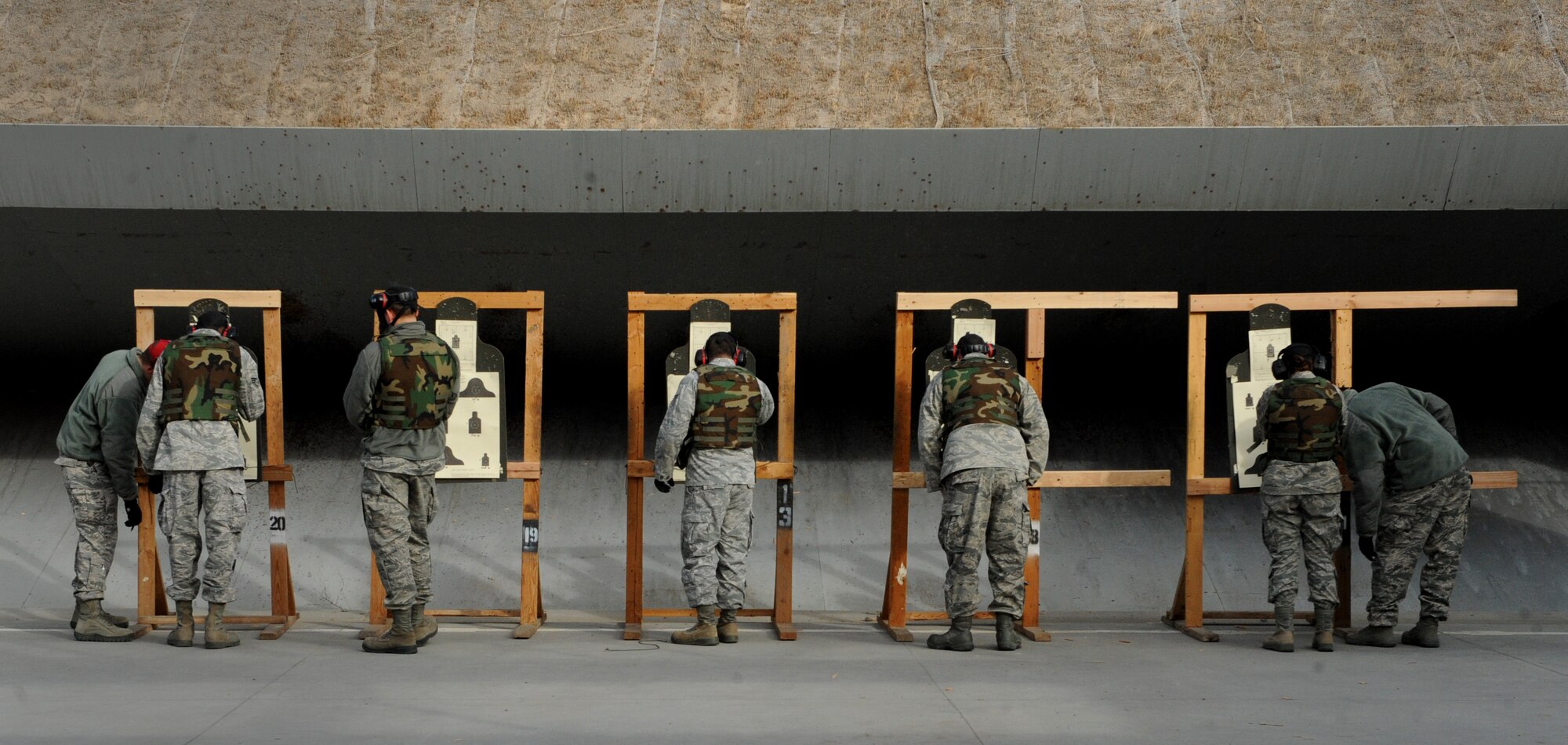 Combat arms instructors and students review targets during the new Air Force Rifle Qualification Course Dec. 14, 2011, at Mountain Home Air Force Base, Idaho. During the new course, Airmen will fire almost twice as many rounds as before at multiple targets. The new course has proven to be difficult, with the base’s pass rate dropping from 94 percent to 61 percent. (U.S. Air Force photo/Senior Airman Alyssa C. Wallace)