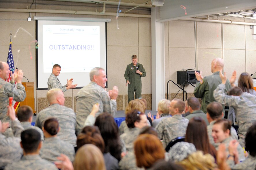 Col. James E. Hougas, AFIA team leader, announces the results of the Air Force Inspection Dec. 12 as the 75th Medical Group members respond to the news. (U.S. Air Force photo/ Todd Cromar)