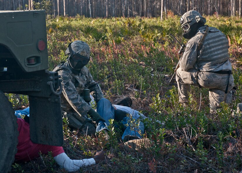 Tactical leaders course students search opposing forces role players during training at the military operations in urban terrain village Dec. 14, 2011, at Moody Air Force Base, Ga. Throughout the training, Airmen learned to be tactically efficient when undergoing real-life missions in a deployed environment. (U.S. Air Force photo by Senior Airman Eileen Meier/Released)