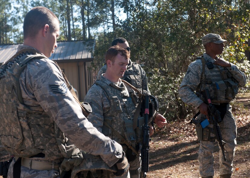 Students with a tactical leaders course take a rest and are briefed by instructors after a scenario that took place at the military operations in urban terrain village at Moody Air Force Base, Ga., Dec. 14, 2011. The Airmen were in the middle of their first 36-hour mission and were being trained to remain vigilant and tactically efficient when entering unpredictable environments in deployed locations. (U.S. Air Force photo by Senior Airman Eileen Meier/Released)
