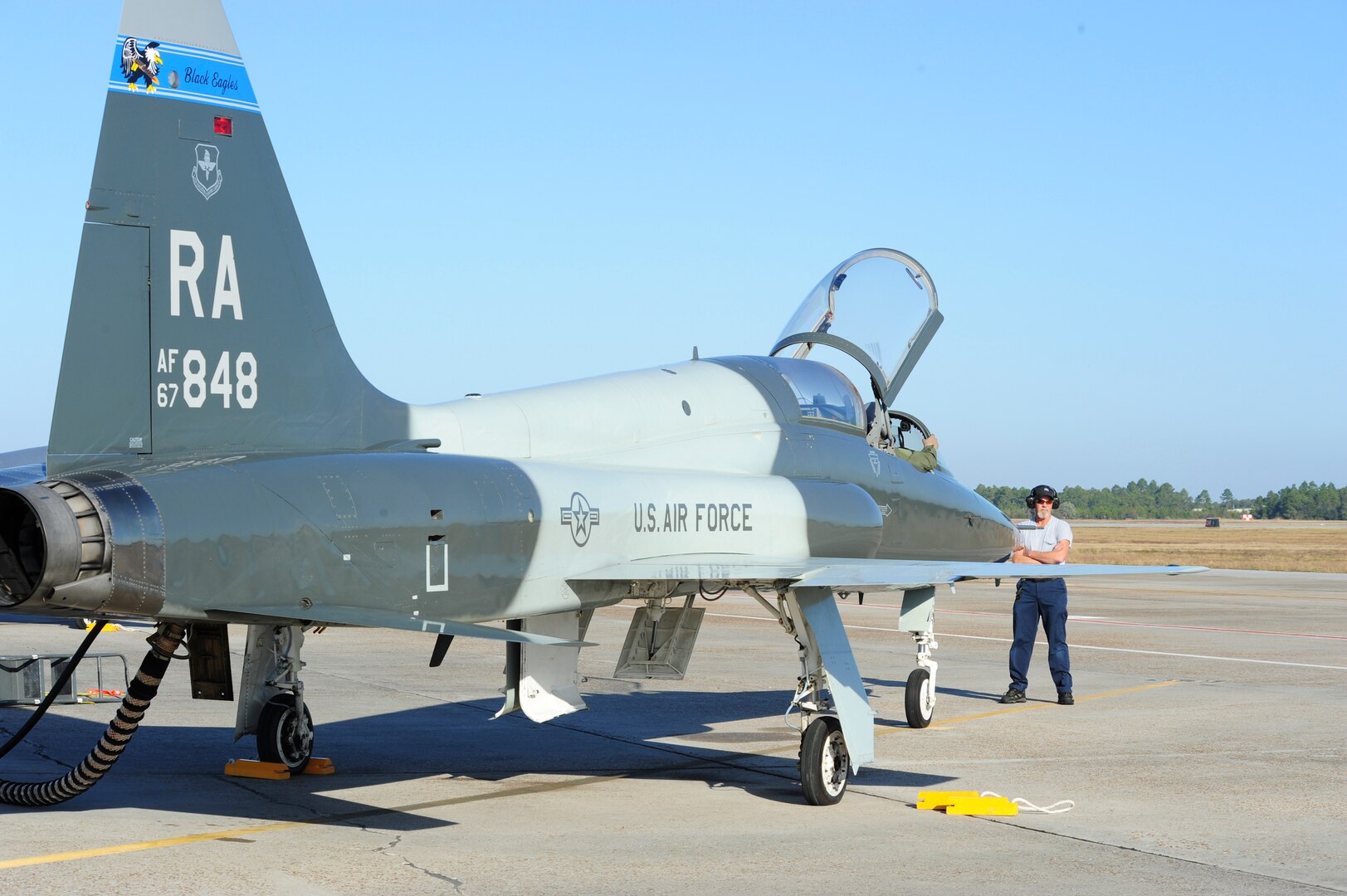 Bill Monk, 12th Maintenance Directorate, waits to marshall the T-38C Talon piloted by Capt. Kevin Welsh, 435th Fighter Training Squadron, prior to take off at Tyndall Air Force Base, Fla., Dec. 15, 2011.  The 12th Flying Training Wing sent a group of 13 pilots and maintainers and five T-38C Talons from Randolph to Tyndall to assist the 325th Fighter Wing in a training exercise.  (U.S. Air Force Photo by LIsa Norman)