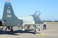 Bill Monk, 12th Maintenance Directorate, waits to marshall the T-38C Talon piloted by Capt. Kevin Welsh, 435th Fighter Training Squadron, prior to take off at Tyndall Air Force Base, Fla., Dec. 15, 2011.  The 12th Flying Training Wing sent a group of 13 pilots and maintainers and five T-38C Talons from Randolph to Tyndall to assist the 325th Fighter Wing in a training exercise.  (U.S. Air Force Photo by LIsa Norman)