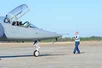 Richard Kilpper, 12th Maintenance Directorate, marshalls a T-38C piloted by Capt. Jeff Shulman, 435th Fighter Training Squadron,at Tyndall Air Force Base, Fla., Dec. 15, 2011.  The 12th Flying Training Wing sent a group of 13 pilots and maintainers and five T-38C Talons from Randolph to Tyndall to assist the 325th Fighter Wing in a training exercise.  (U.S. Air Force Photo by LIsa Norman)