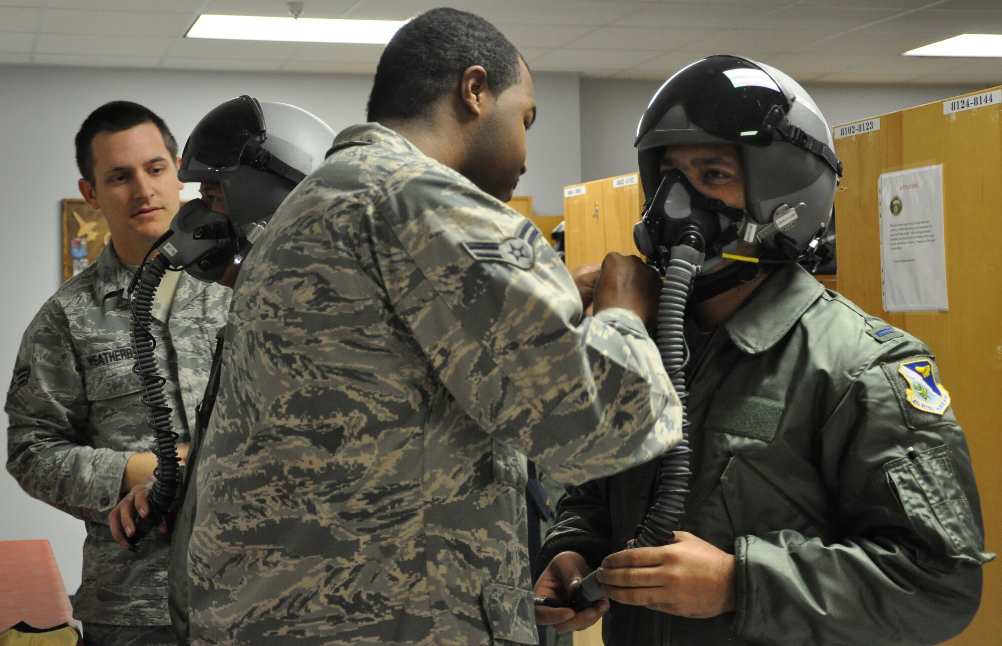 LAUGHLIN AIR FORCE BASE, Texas—Senior Airman Richard Weatherby,47th Operations Support Squadron, and Airman 1st Class Alexander King, 47th OSS, prepare to test the masks on two Afghan lieutenants going through Specialized Undergraduate Pilot Training. Three Afghan lieutenants are the first from Afghanistan to attend SUPT at Laughlin and are scheduled to graduate here Dec. 16. (U.S. Air Force photo/2nd Lt. Angela Martin) 