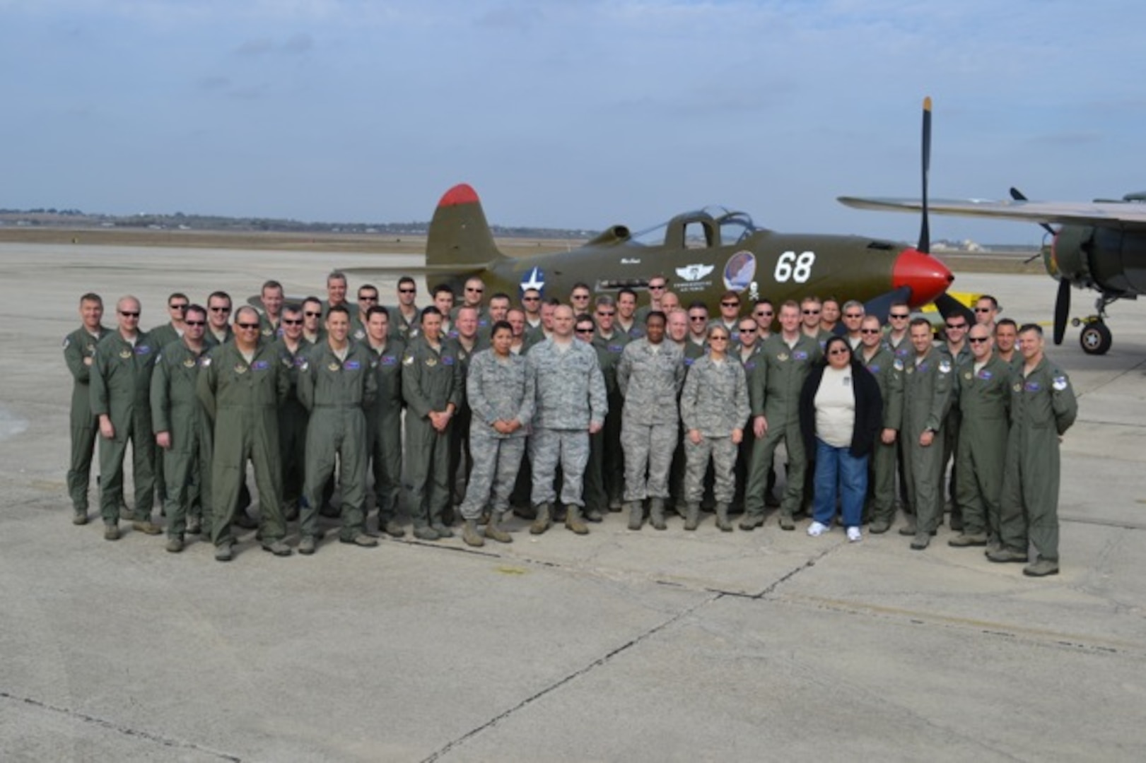 Current members of the 39th Flying Training Squadron pose for a group photo in front of a P-39, the airframe assigned to the unit while it conducted antisubmarine patrols along the West Coast in the days and weeks following the attack on Pearl Harbor.  As a reserve associate unit to the 12th Flying Training Wing, the now 39th FTS was moved to Randolph AFB, Texas in September 2007 and trains instructor pilots.(Courtesy Photo)