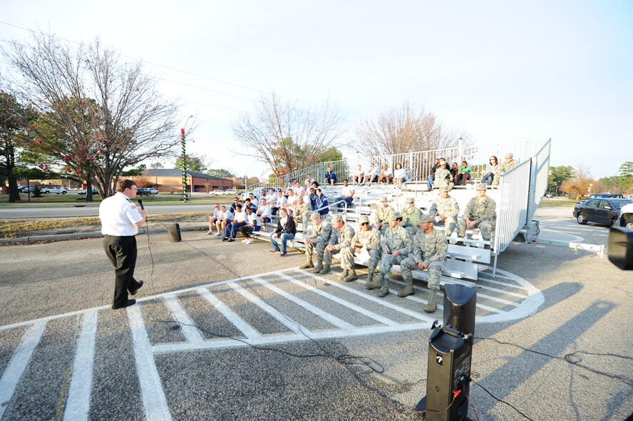 Sean Quinby, 4th Civil Engineer Squadron fire department chief, gives the audience background information on Christmas tree fires before demonstrating how fast they can go up in flames in the parking lot of the Xchange on Seymour Johnson Air Force Base, N.C., Dec. 14, 2011.  Live trees must have their water level checked every day to ensure the tree does not dry out. Quinby is a native of Seattle. (U.S. Air Force photo by Senior Airman Rae Perry)