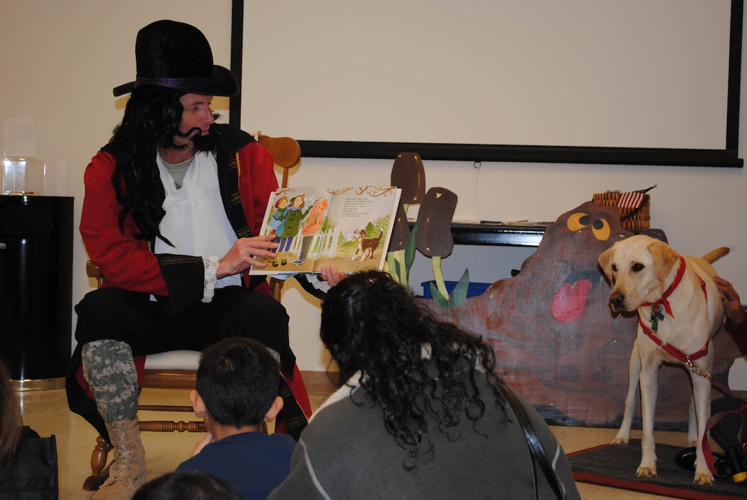 Lt. Col. Layton G. Dunbar Jr., 24th Transportation Battalion commander, also known as Lord Licorice, reads “Snip, Snip ... Snow” to the children at Execptional Family Member Program’s Empowerment Hour: Candy Land Adventure. (Photo by Toni Guagenti)