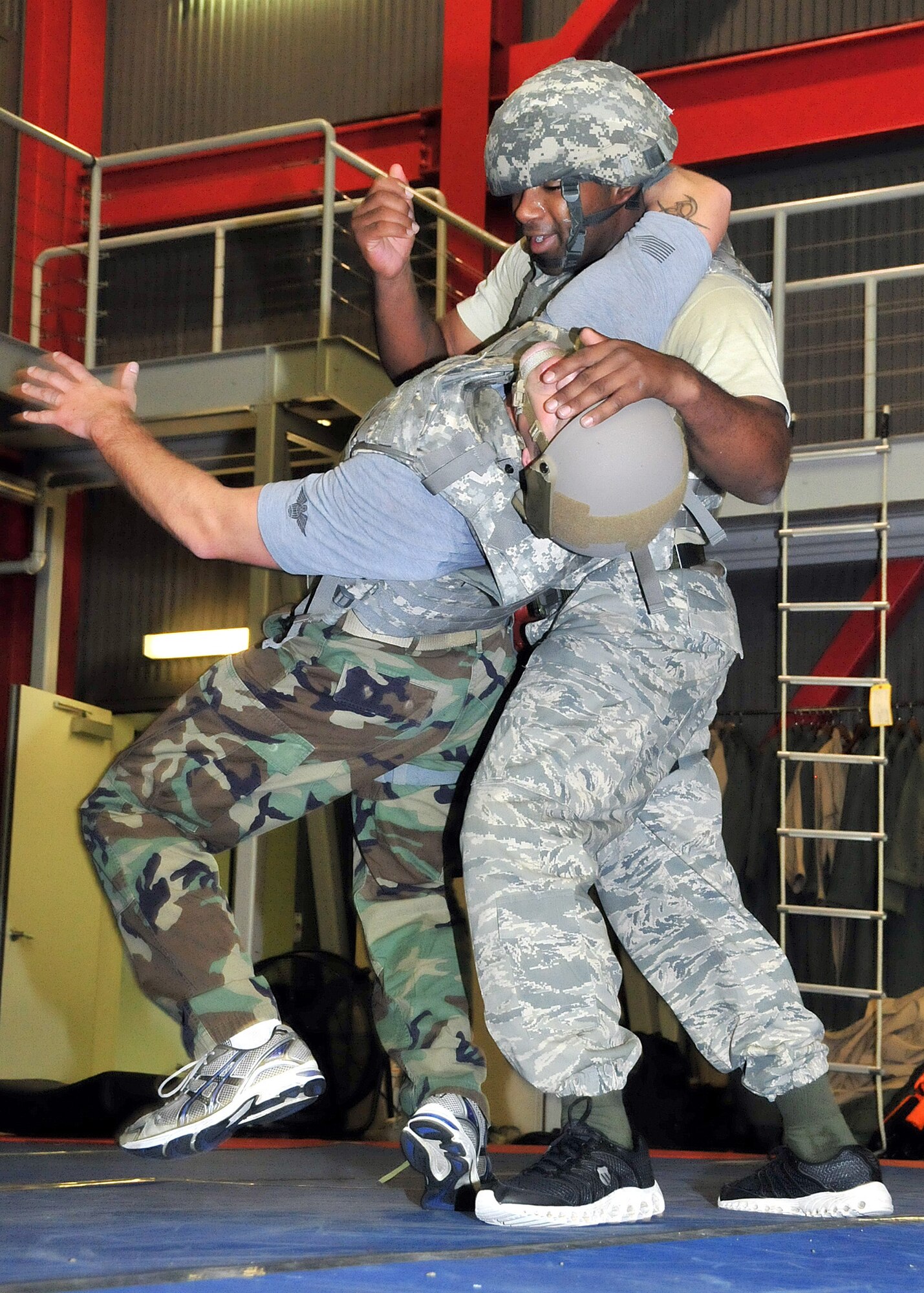 Staff Sgt. Brandon Gaines, 571st Mobility Support Advisory Squadron vehicle maintenance air advisor, defeats Staff Sgt. Daniel Foret's, 571st MSAS Survival, Evasion, Resistance and Escape specialist, headlock from the side by putting him off balance and delivering hammer strikes to the face during the weeklong Krav Maga Worldwide instructor course which concluded Dec. 4 in the SERE building. (U.S. Air Force photo/Tech. Sgt. Lesley Waters)