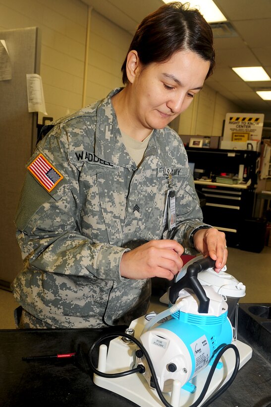Sgt. Jacquelyn Waddell, McDonald Army Health Center biomedical technician, fixes the handle on an aspirator, a machine used to remove bodily fluids from a patient. (U.S. Air Force photo by Staff Sgt. Ashley Hawkins/Released)