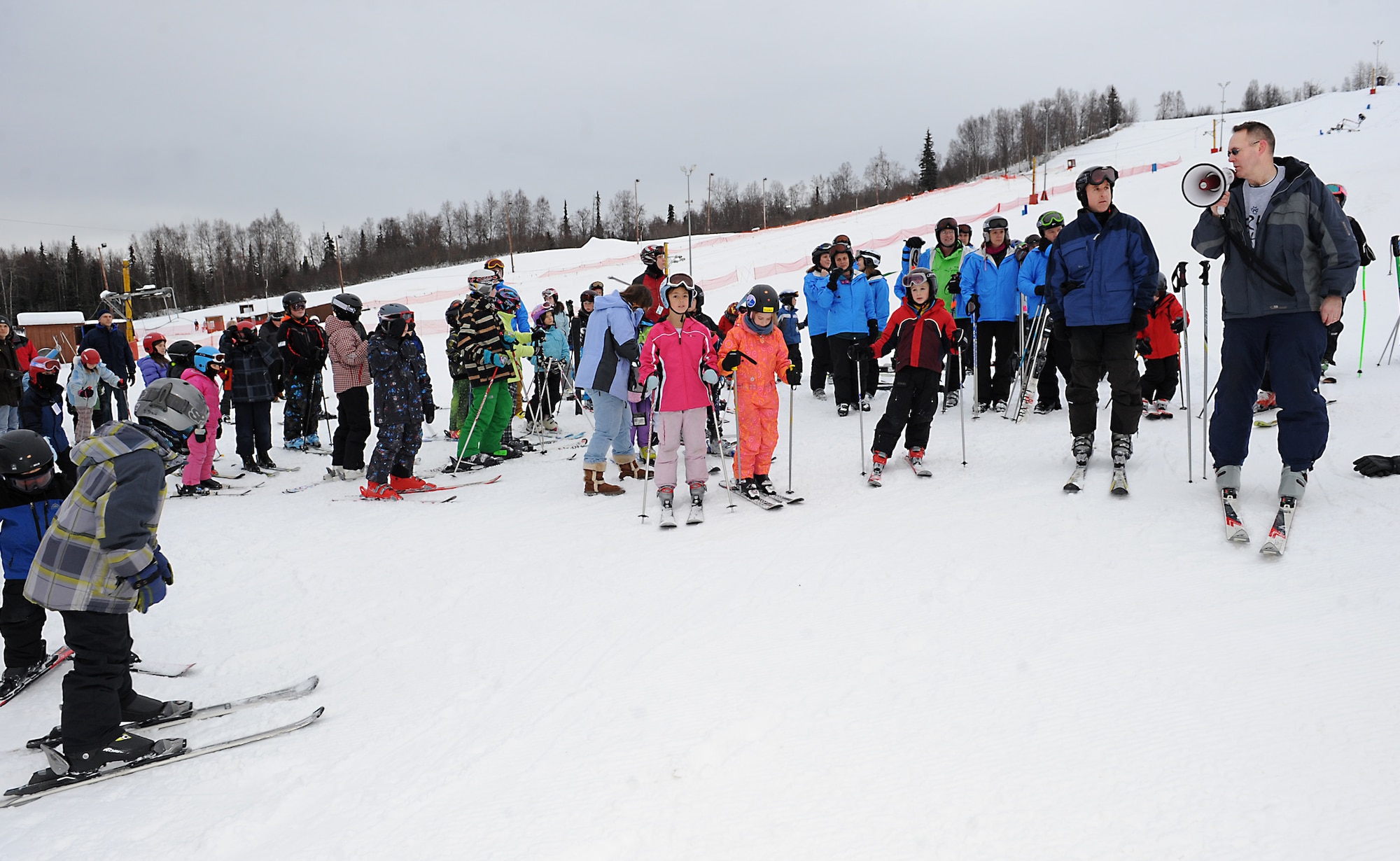 JOINT BASE ELMENDORF-RICHARDSON, Alaska -- Army Col. Timothy Prior, 673d ABW vice wing commander, and Air Force Col. Edward Thomas, 673d Mission Support Group commander, announce the opening of Hillberg Ski Area Dec. 3. Both commanders made the first trip down the ski hill to officially start the season. Hillberg is now open Friday through Sunday from noon to 8 p.m.  (U.S. Air Force photo/Staff Sgt. Cynthia Spalding)