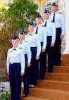 From top to bottom: Husband and father, Lt. Col. Curtis Davis, Air Education and Training Command, stands on the top of the steps at his home with his family; sons, 1st Lt. Trent Davis, 963rd Airborne Air Control Squadron at Tinker Air Force Base, Okla., and 2nd Lt. Austin Davis, Air Force Space Command at Peterson AFB, Colo.; daughter 2nd Lt. Shannon Davis, 315th Training Squadron at Goodfellow AFB, Texas; wife Lt. Col. Susan Davis, 59th Training Squadron commander, Lackland AFB; and daughter Air Force cadet Arieal Davis.