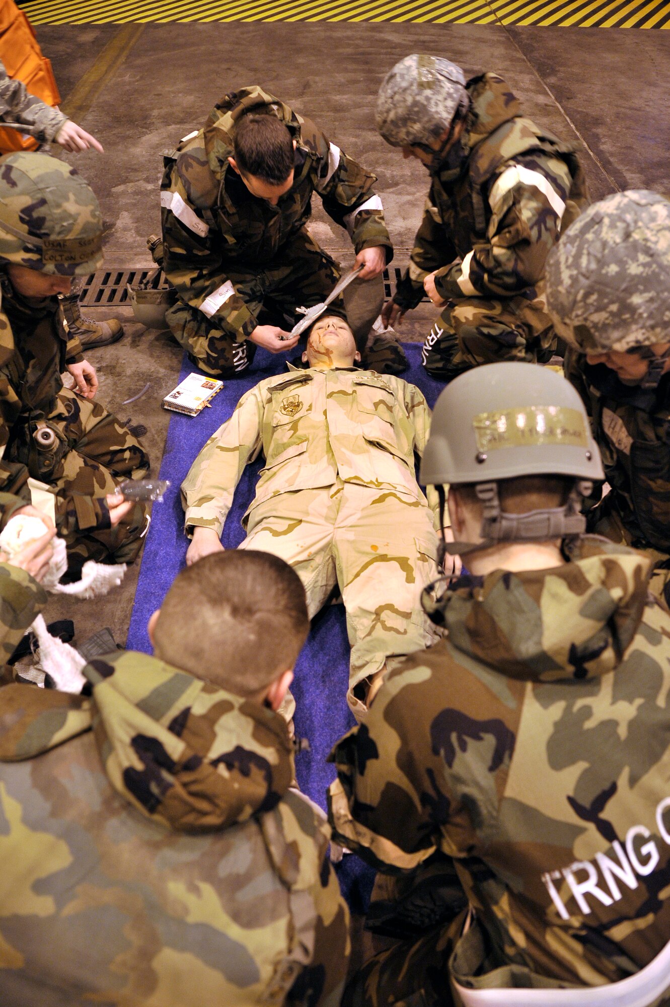 U.S. Air Force Airmen perform self-aid buddy care during an Operation Readiness Exercise Dec. 12, 2011, Eielson Air Force Base, Alaska. The exercise gave Airmen an opportunity to become familiar with medical kits and weapons handling. (U.S. Air Force photo by Staff Sgt. Christopher Boitz/Released)