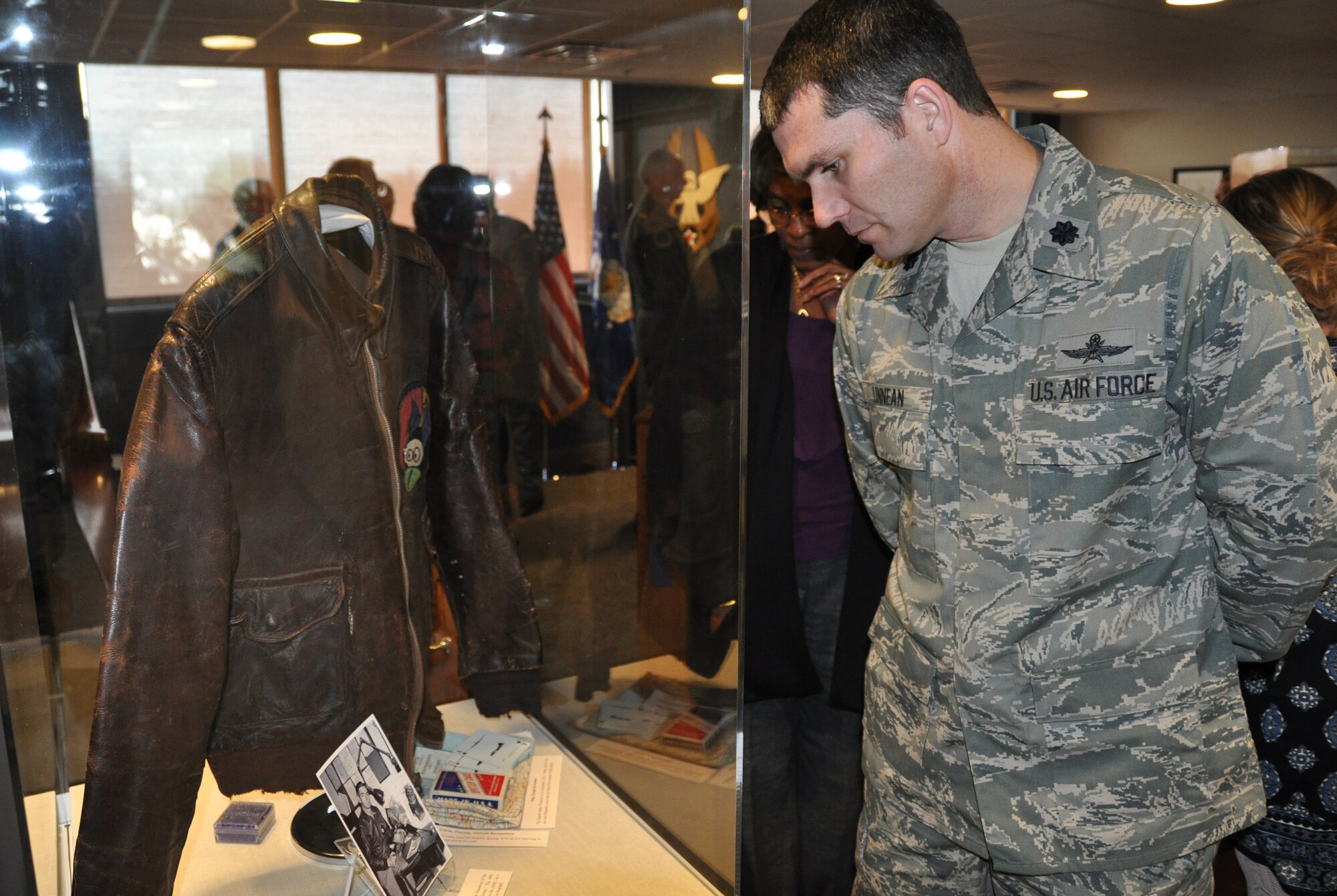 Lt. Col. Harold Linnean looks at the World War II bomber jacket worn by an Airman with the 506th Squadron, 44th Bombardment Group, which is now the 44th Fighter Group, an Air Force Reserve unit at Holloman Air Force Base, N.M. Air Force Reserve Command inaugurated a Heritage Hall in the command's headquarters building at Robins Air Force Base, Ga., on Dec. 15. The display brings together pieces of history that give Reservists and visitors to the headquarters building a chance to see the contributions of Reservists since World War I. (U.S. Air Force photo/Philip Rhodes)