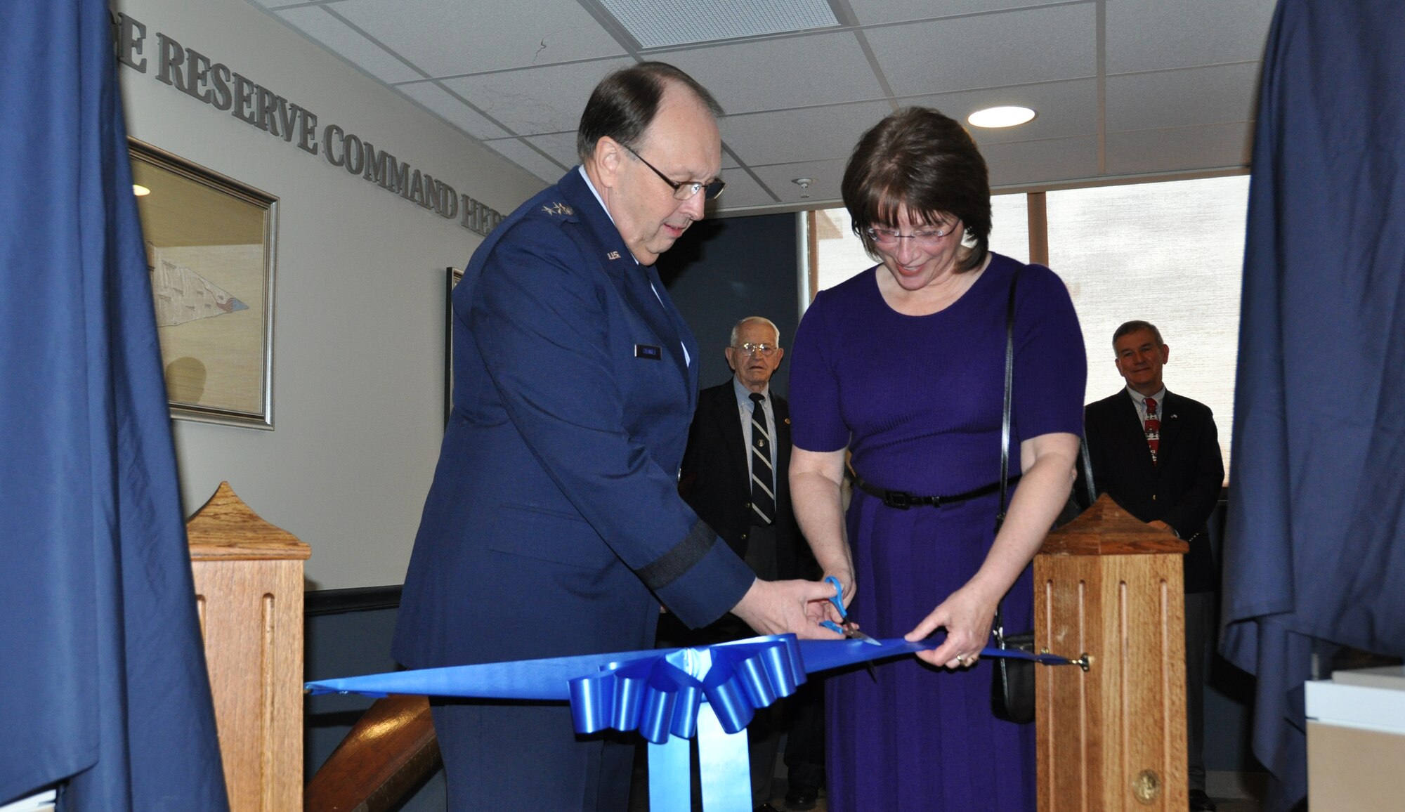 Lt. Gen. Charles E. Stenner, Jr., commander Air Force Reserve Command, and Betty Kennedy, command historian, cut the ribbon to officially open the AFRC Heritage Hall in the command headquarters building on Robins Air Force Base, Ga., Dec. 15. The exhibit consists of the first floor inner lobby, second floor command entrance, third floor lobby and the main conference room hallway. (U.S. Air Force photo/Philip Rhodes)