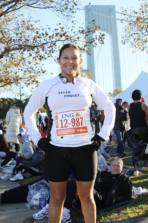 U.S. Air Force Staff Sgt. Megan Cotter, 355th Medical Group noncommissioned officer in charge of immunizations, poses for a picture before running in the New York City marathon Nov. 6. She wears her shirt which has the names of five U.S. Army soldiers who were killed in Afghanistan. Sergeant Cotter and her medical team provided aid to them while deployed to Afghanistan. (Courtesy photo)