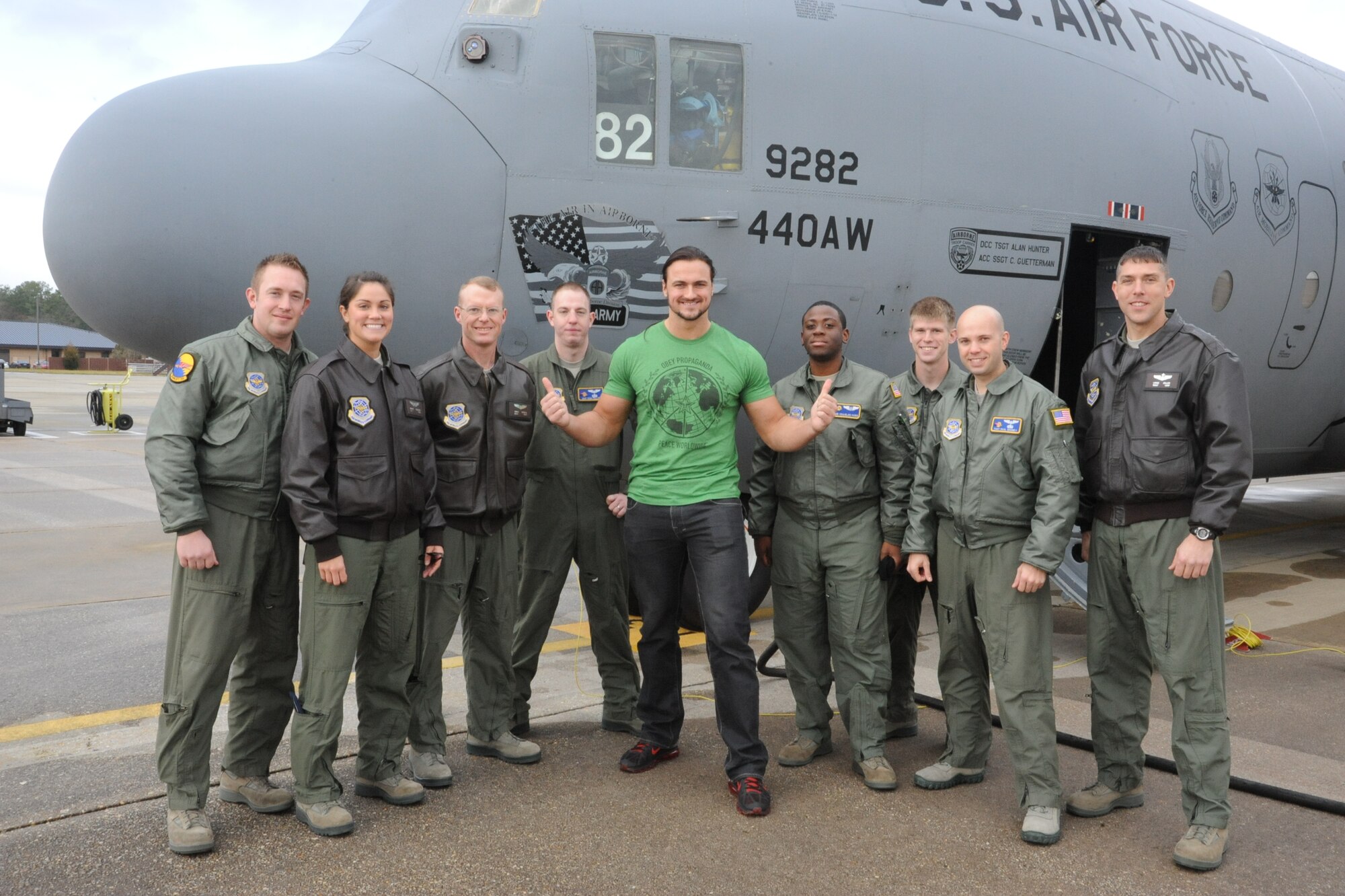 World Wrestling Entertainment wrestler Drew McIntyre (center) with Airmen of Pope Field. McIntyre was one of four wrestlers that visited locations on Pope Field Dec. 9, 2011 as part of the WWE Tribute to the Troops. (U.S. Air Force photo by Lisa Moore 440 AW PA)