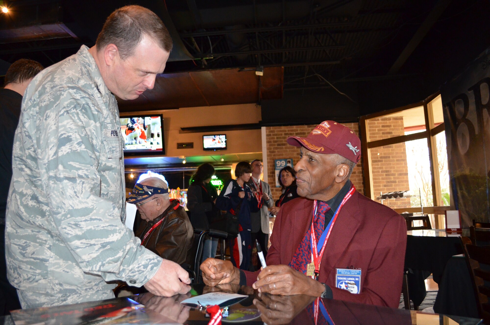 Col. Craig Petersen, Commander, 433rd Mission Support Group, Lackland Air
Force Base, talks with Dr. Granville Coggs a Documented Original Tuskegee Airman after a private screening of "Double Victory" a Tuskegee Airmen documentary and the upcoming Tuskegee Airmen movie, "Red Tails" at the at Santikos Rialto Theatre in San Antonio,
Dec. 10. (U.S. Air Force photo/ Senior Airman Viola M. Hernandez) 
