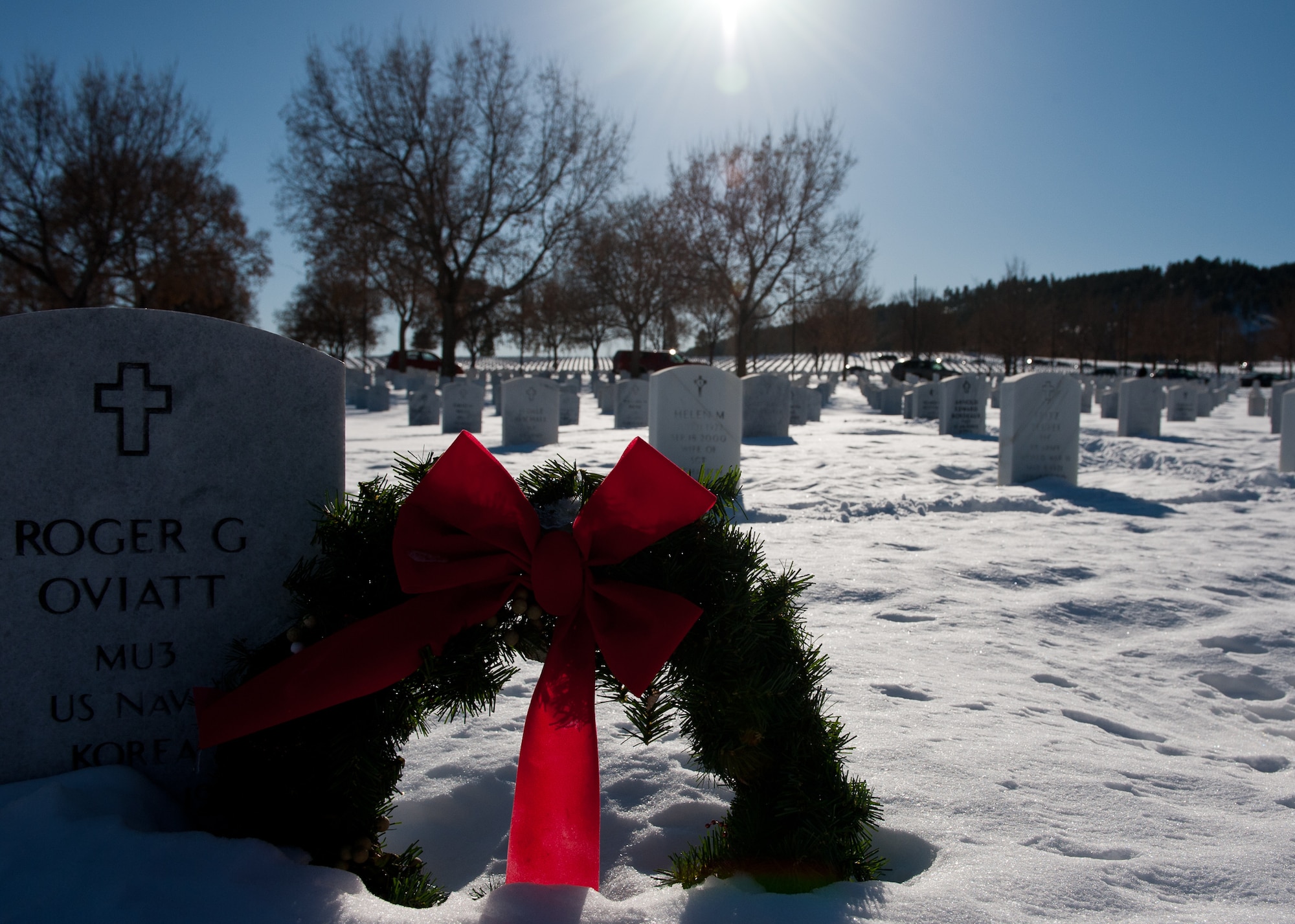 A wreath sits in front of a headstone during the Wreaths Across America ceremony at the Black Hills National Cemetery near Sturgis, S.D., Dec. 10, 2011. Residents of the Black Hills community raised money to buy wreaths to be placed at each headstone as part of the event that honors servicemembers and their families. (U.S. Air Force photo by Airman 1st Class Kate Thornton/Released)
