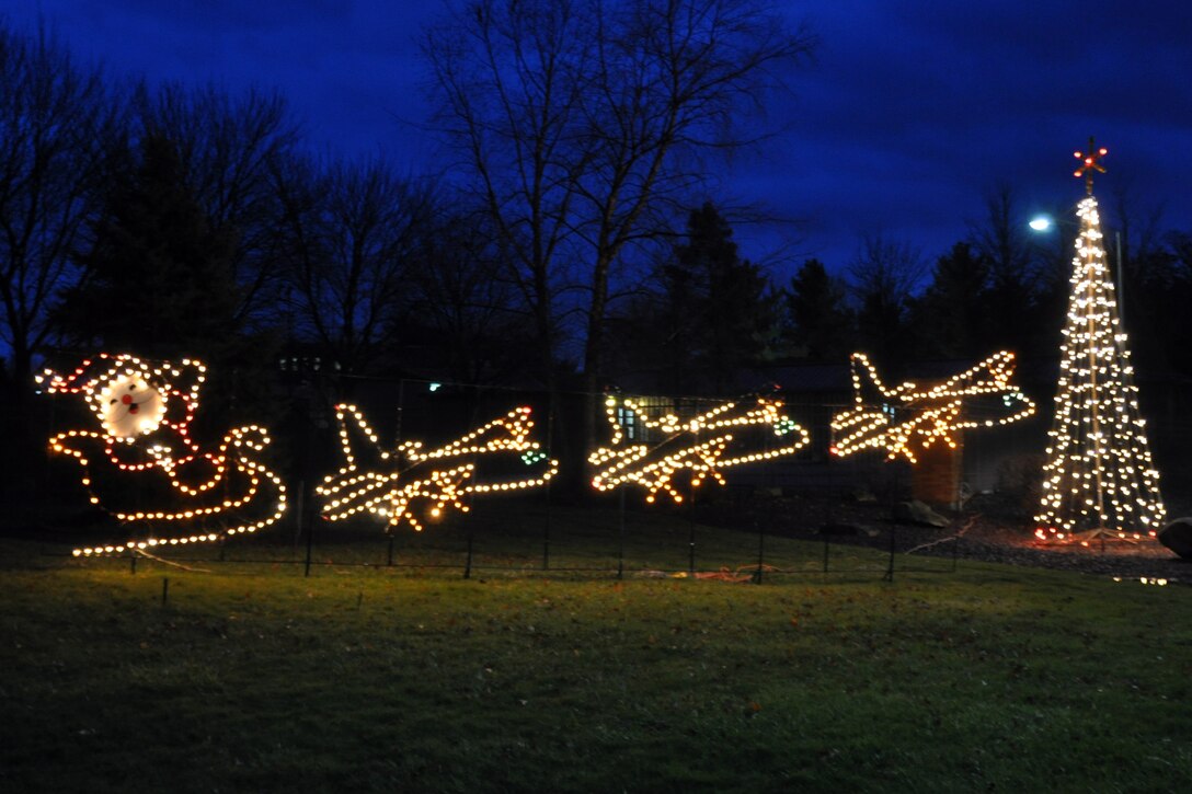 A holiday tradition at Youngstown Air Reserve Station, Rick Gless, Harvey Martin and Mike Yuhasz, base contractors from EAST recently set up and lit a Christmas tree and Santa's sleigh towed behind three C-130s. The decorations are visible by the main gate.
