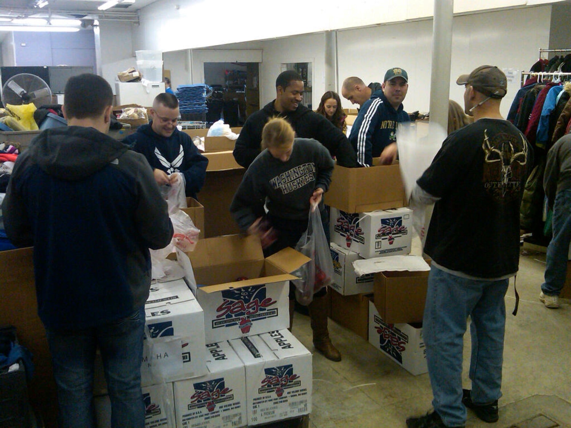 Members of the 343rd Recruiting Squadron sort donated clothes at the Open Door Mission in Omaha, Neb., Dec. 7.  Eleven members spent the entire day unloading thousands of pounds of donated goods, stocking shelves and filling bags for needy Omaha residents. (U.S. Air Force Photo/Lt. Col. Stephen A. Polomsky)