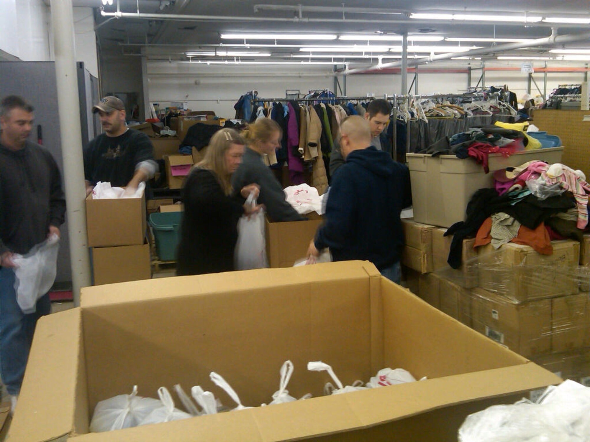 Members of the 343rd Recruiting Squadron sort donated clothes at the Open Door Mission in Omaha, Neb., Dec. 7.  Eleven members spent the entire day unloading thousands of pounds of donated goods, stocking shelves and filling bags for needy Omaha residents. (U.S. Air Force Photo/Lt. Col. Stephen A. Polomsky)