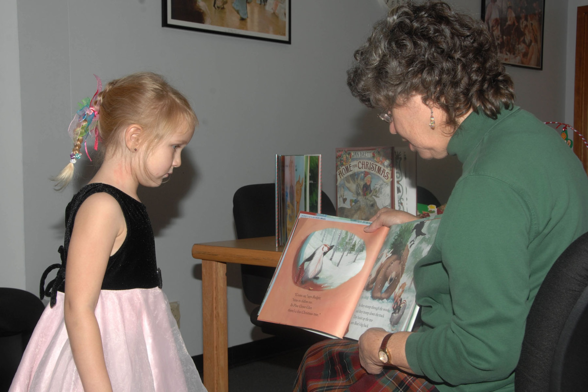 HANSCOM AIR FORCE BASE, Mass. - Clara Murray listens to a story read by librarian Pam Medolo during Preschool Storytime at the base library Dec. 8. The children listened to three holiday-themed stories and made crafts afterwards. (U.S. Air Force photo by Linda LaBonte Britt)