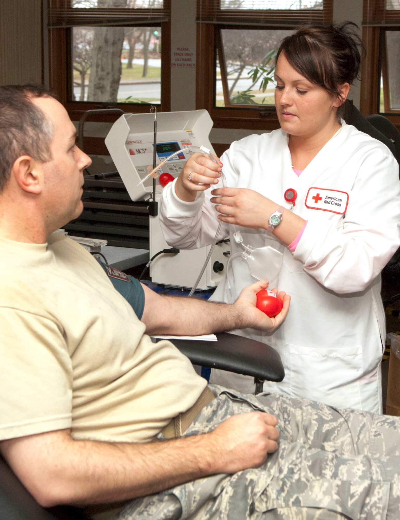 HANSCOM AIR FORCE BASE, Mass. – Samantha Charbonneau, a collection specialist with the Red Cross, monitors Maj. Carl Wiswell, the Integration Support branch chief, while he donates blood during a blood drive at the base chapel on Dec. 6. Base personnel were invited to walk-in or make appointments to donate. (U.S. Air Force photo by Mark Wyatt)