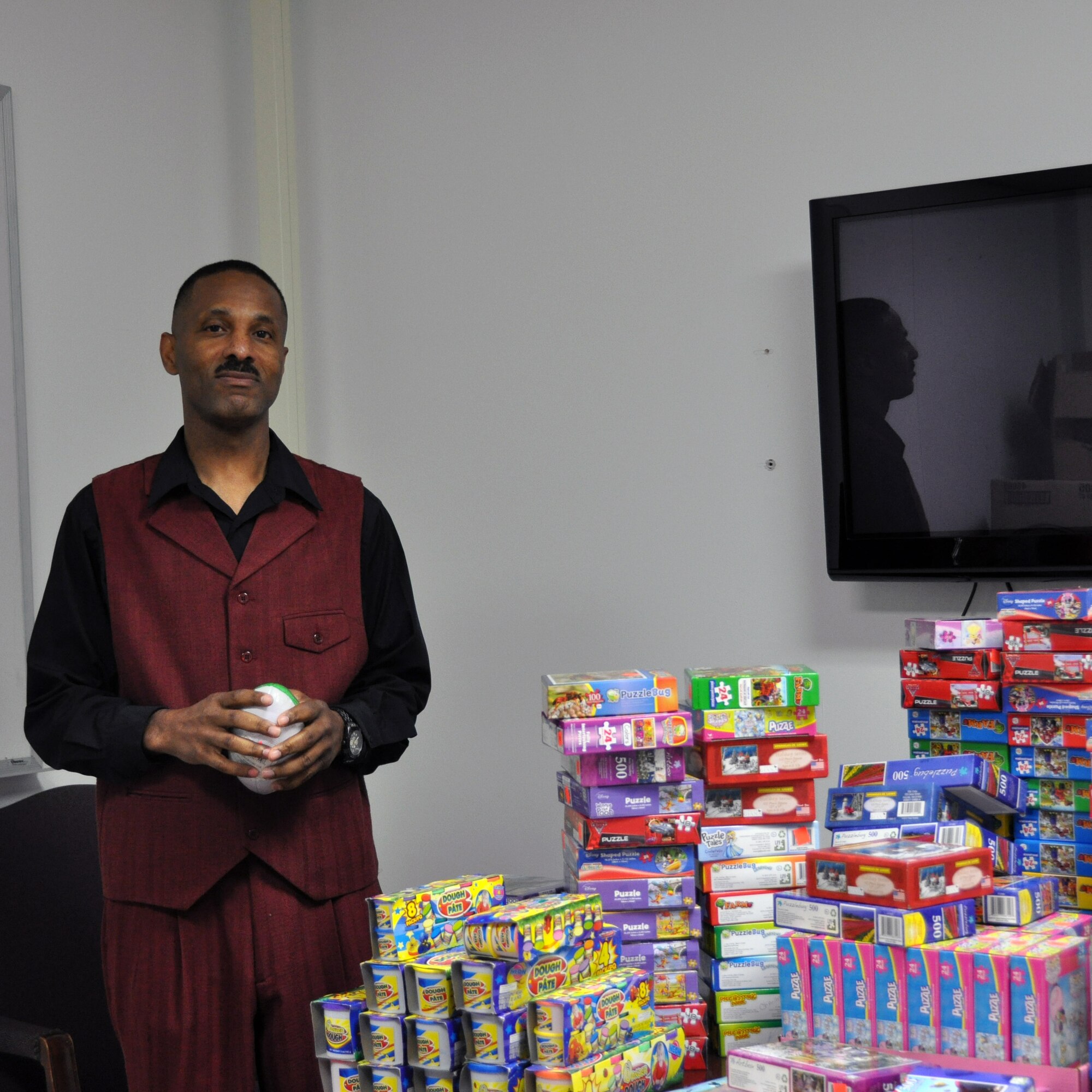 (Retired) Senior Master Sgt. Terry Wilson poses in front of toys donated Dobbins.  He led members of the 94th Security Forces Squadron in providing toys to Dobbins Airmen and their families this winter. (U.S. Air Force photo/ Senior Airman Danielle Purnell)
