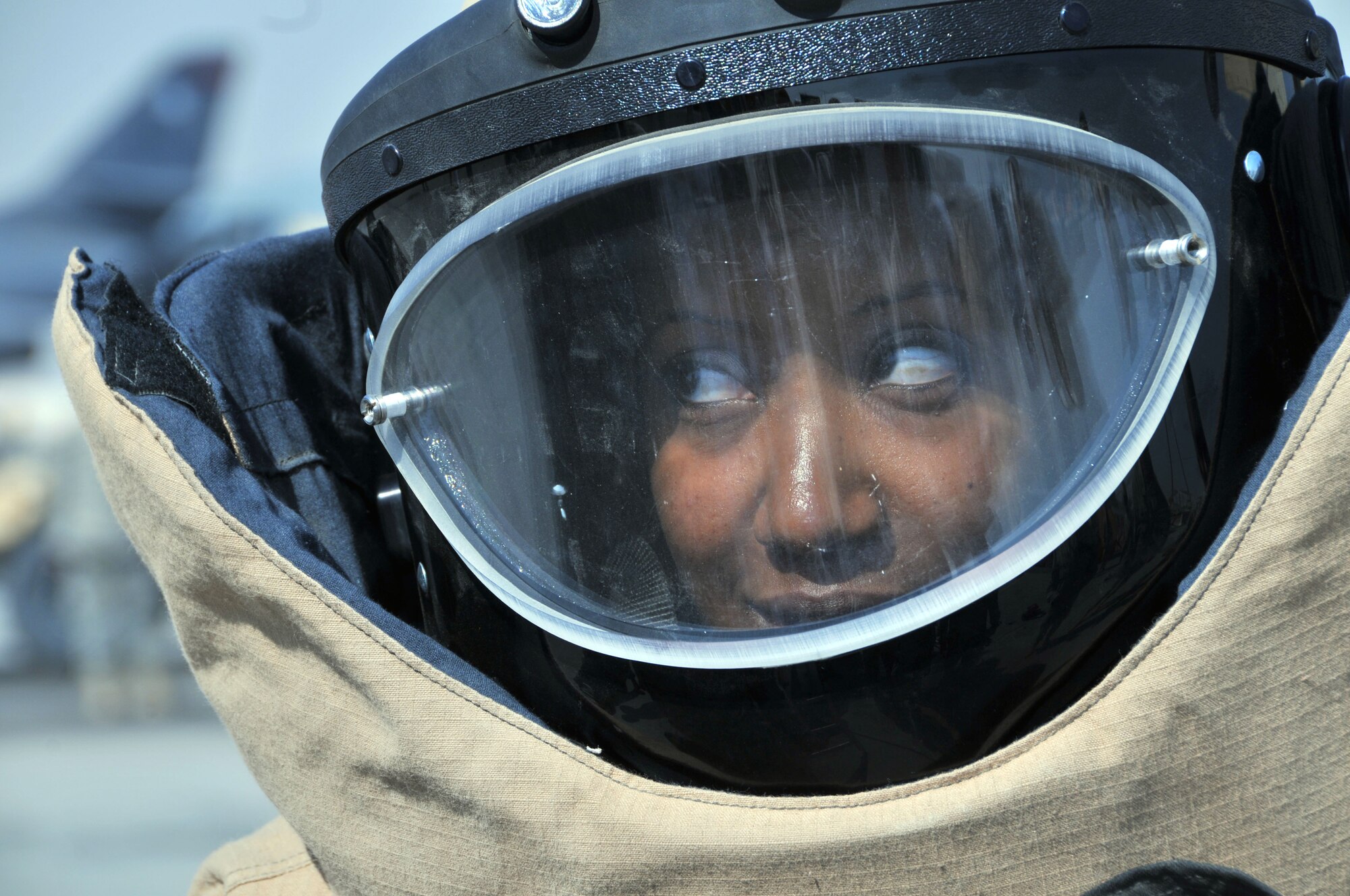 Tech. Sgt. Daneirys Liranzo, 379th Expeditionary Communication Squadron cyber transport systems technician, gets the feel for an explosive ordnance disposal bomb suit during the 2011 Flightline Fest at an undislcosed location in Southwest Asia Dec. 15, 2011. The 379th Air Expeditionary Wing hosts the annual event to offer service members the opportunity to examine first-hand the aircraft that execute the wing's expeditionary mission. Various units from the wing as well as units from coalition partners put on demonstrations and displays to educate people on how they cooperate with each other to accomplish the mission. (U.S. Air Force photo/Senior Airman Eric Summers Jr.)