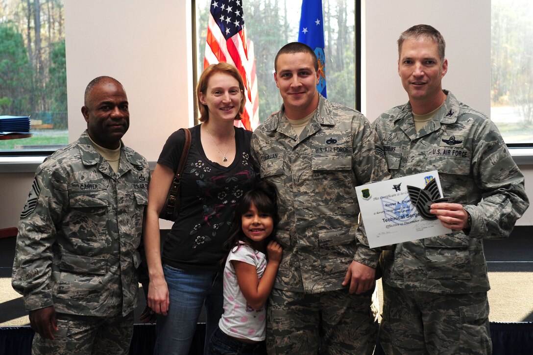 U.S. Air Force Col. Kevin Robbins, 1st Fighter Wing commander, and Chief Master Sgt. Gary Carter, 1st FW command chief, present Tech. Sgt. Reese Delavan, 1st Maintenance Squadron munitions inspector, with a Stripes for Exceptional Performers certificate and technical sergeant's insignia at Langley Air Force Base, Va., Dec. 13, 2011. Delavan was promoted to technical sergeant as part of the STEP Program, designed to promote noncommissioned officers who demonstrate excellent performance. (U.S. Air Force photo by Airman 1st Class Kayla Newman/Released)