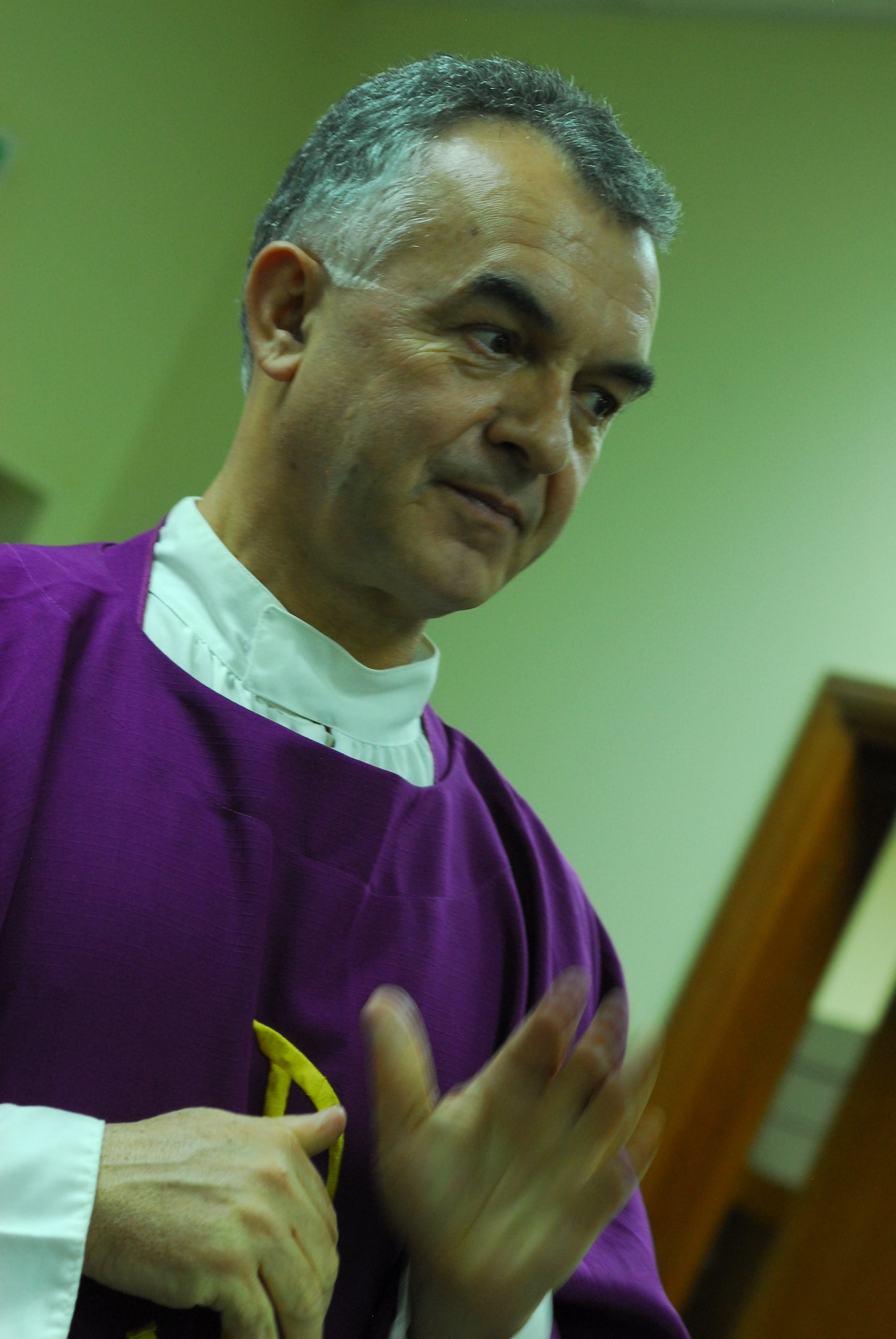 Chaplain (Lt. Col.) Jacek Kowalik, 332nd Air Expeditionary Wing Catholic priest, offers a benediction at a Mass held Nov. 28, 2011 at an undisclosed location in Southwest Asia. Kowalik is a native of Parszow, Poland and is deployed from Spangdahlem Air Base, Germany. (U.S. Air Force photo by 1st Lt. Rusty Ridley)