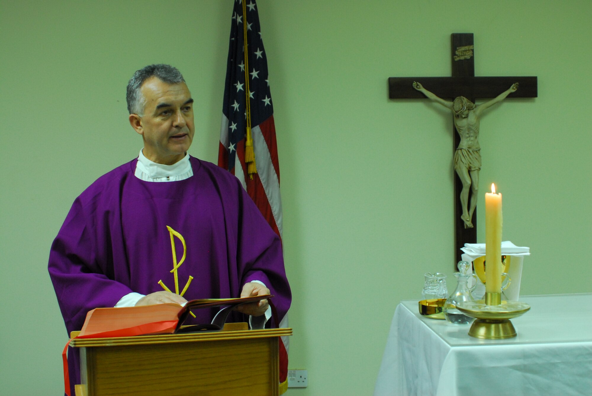 Chaplain (Lt. Col.) Jacek Kowalik, 332nd Air Expeditionary Wing Catholic priest, reads from the Gospels at a Mass held Nov. 28, 2011 at an undisclosed location in Southwest Asia. Kowalik is a native of Parszow, Poland and is deployed from Spangdahlem Air Base, Germany. (U.S. Air Force photo by 1st Lt. Rusty Ridley)