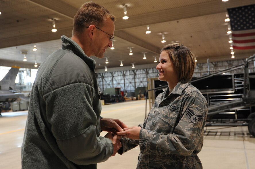 Brig. Gen. Mark McLeod, Pacific Air Forces director of logistics, presents a coin to Senior Airman Jessica Hoerres, 35th Maintenance Squadron, during his visit at Misawa Air Base, Japan, Dec. 14, 2011. Hoerres, a Boston, Mass. native, received a coin for her outstanding performance during the 35th Fighter Wing's operational readiness inspection. (U.S. Air Force photo/Airman 1st Class Kia Atkins) 
