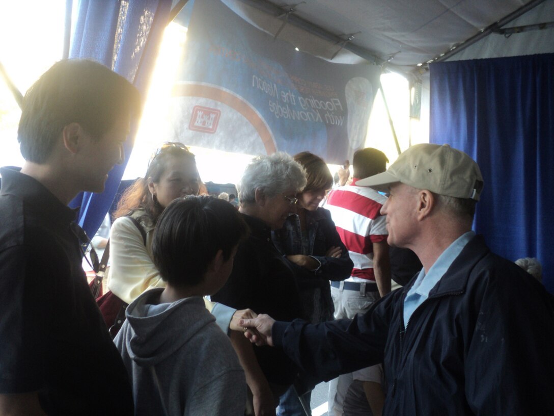 WASHINGTON, D.C. — Maj. Gen. Merdith “Bo” Temple, U.S. Army Corps of Engineers deputy commander, talks with parents at the U.S. Army Corps of Engineers exhibit at the first USA Science and Engineering Festival Expo on the National Mall. U.S. Army Corps of Engineers employees from offices in the Washington, D.C., area and the U.S. Army Engineer Research and Development Center (ERDC) laboratories participated in the Expo on Oct. 23 - 24, 2010 to help inspire the next generation of scientists and engineers who will be needed to support the Corps’ mission. As part of the Expo, students played interactive games on levee flood risks that were developed by an ERDC team. (U.S. Army Corps of Engineers photo by Mary Roko)