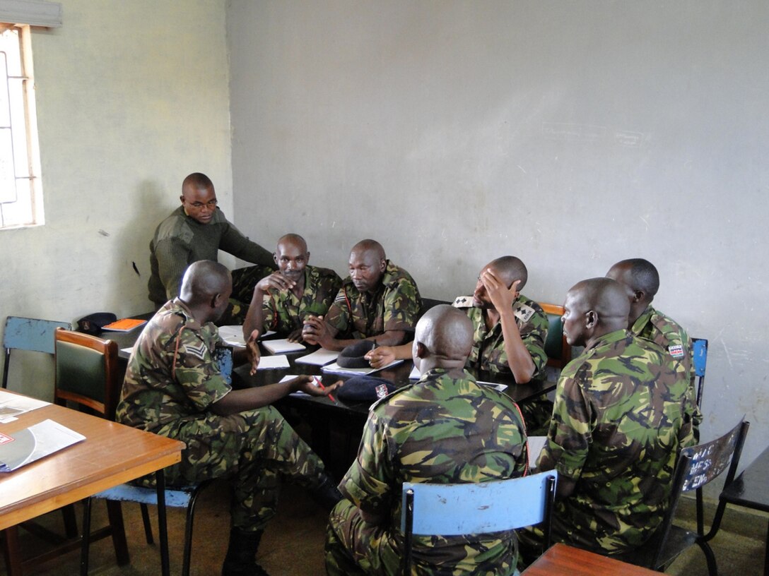 KENYA, Africa — Kenyan students take a peek at the next slides in their print outs in class during the U.S. Army Corps of Engineers Kenya Army Engineer Training Program. (U.S. Army Corps of Engineers photo)