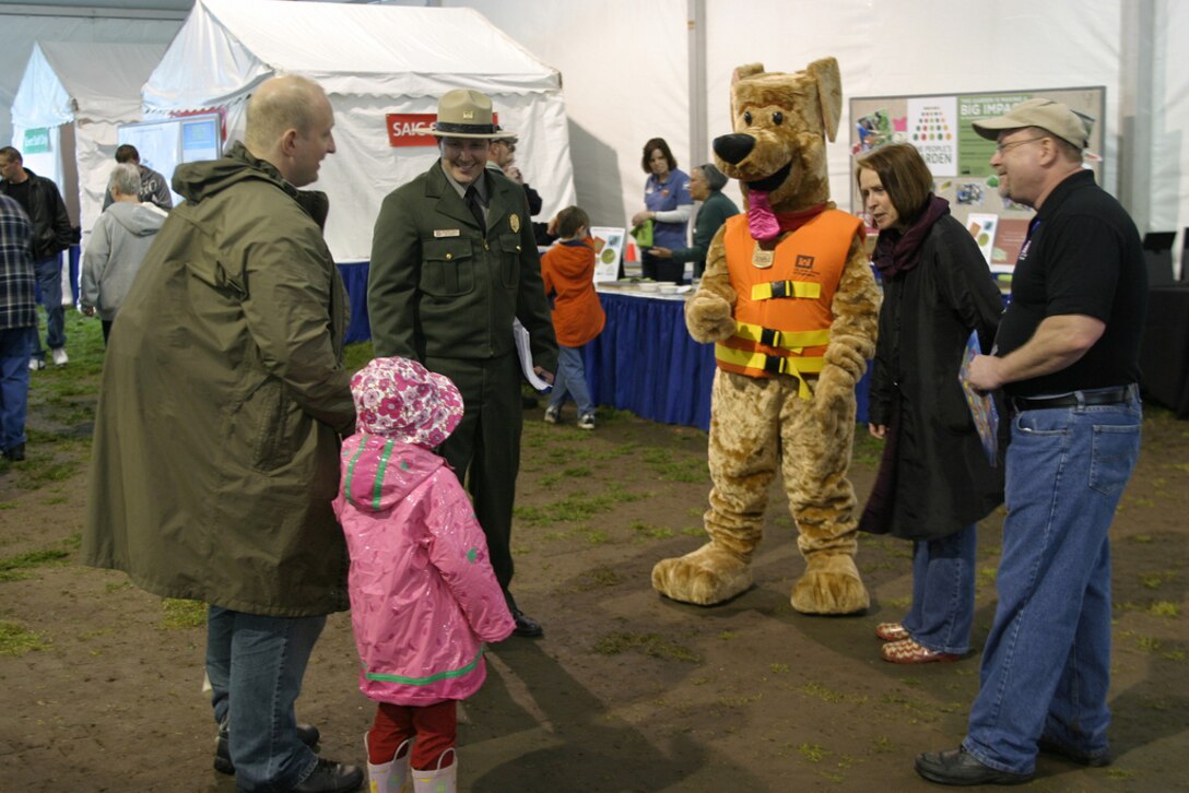 WASHINGTON, D.C. — Bobber the Water Safety Dog, U.S. Army Corps of Engineers Park Ranger Carlisle, Hon. Jo-Ellen Darcy, Assistant Secretary of the Army (Civil Works), and Steve Austin chat at the EPA Earth Day event on the National Mall here, April 16, 2011. (U.S. Army Corps of Engineers photo by John Hoffman)