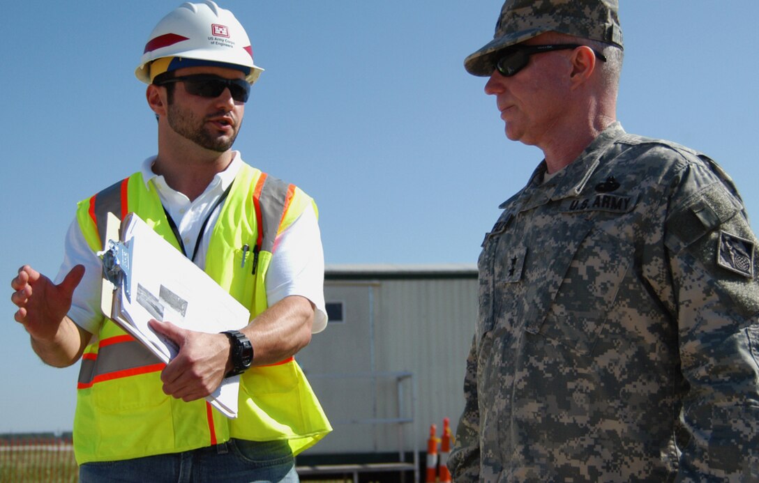 JOPLIN, Mo. -- Simon Fet, manager of the U.S. Army Corps of Engineers temporary housing mission here, describes progress made on two temporary housing sites to Major Gen. Merdith W. B. "Bo" Temple, acting chief of engineers and acting commanding general of USACE, during a visit July 19. While here, Temple visited with Corps employees and reviewed construction of temporary school facilities and debris removal. Fet is a deployed employee from the Corps' Huntington District, located in Huntington, W.Va. More than 300 Corps employees have volunteered to serve in support of federal recovery operations here. (U.S. Army photo/Mark Haviland)