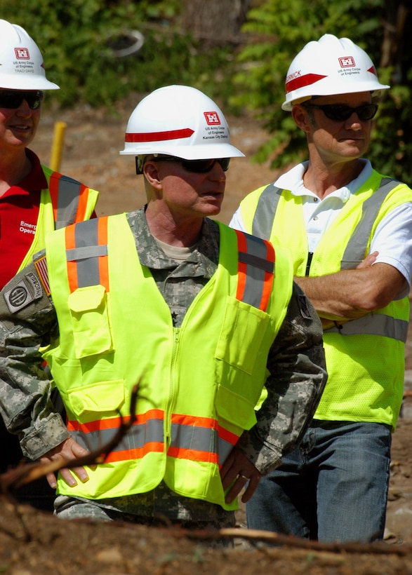 JOPLIN, Mo. -- Joined by Traci Davis, quality assurance supervisor, and Jon Gornick, mission manager for debris removal,  Maj. Gen. Merdith W. B. "Bo" Temple, acting chief of engineers and acting commanding general of USACE, surveys the expedited debris removal area here July 19. It’s estimated that more than 6,900 homes were destroyed and an additional 875 damaged when an EF-5 tornado struck here May 22. Gornick is deployed here from the Corps' Portland District in Oregon and Davis is deployed from the Kansas City District. To date, more than 300 Corps employees have volunteered to help with federal tornado recover efforts here. (U.S. Army photo/Mark Haviland)