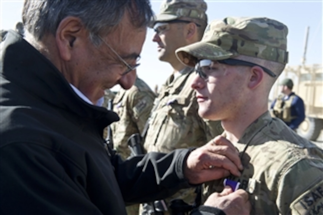 Secretary of Defense Leon E. Panetta presents a Purple Heart to a soldier with the 172nd Infantry Brigade at forward operation base Sharana, Afghanistan, on December 14, 2011.  Panetta began the day awarding 12 Purple Hearts to soldiers at the forward operation base.  