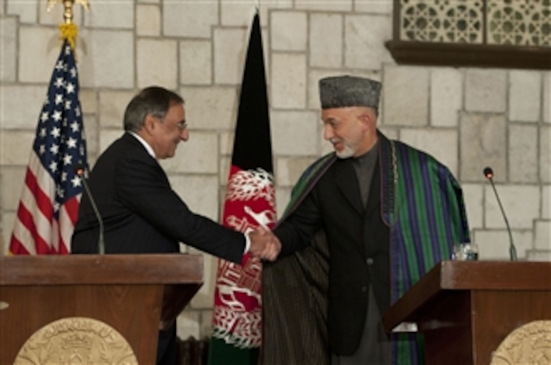 Secretary of Defense Leon E. Panetta shakes hands with President Hamid Karzai at a press conference in Kabul, Afghanistan, on December 14, 2011.  Panetta stated that the U.S. is committed to working with the Afghan government to produce a free and independent country.  