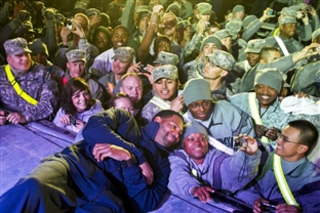 Robert Horry poses for a photo with a soldier after a USO show in Camp Buehring, Kuwait, Dec. 14,  2011.