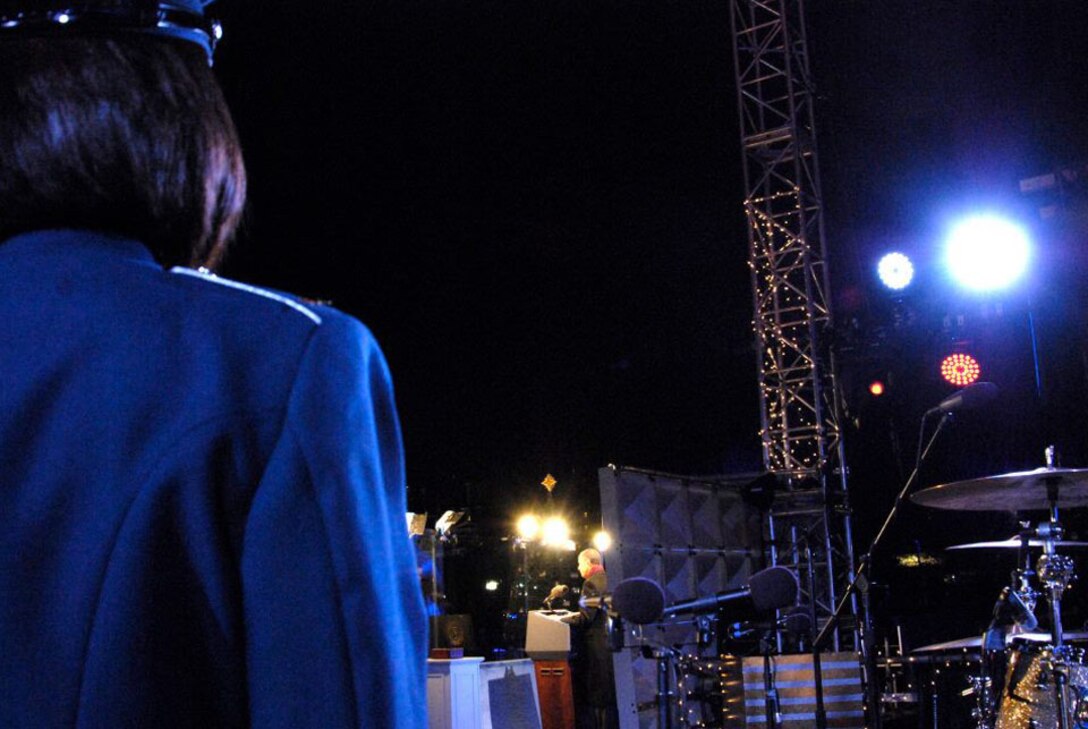 2nd Lt. Shanti Nolan, U.S. Air Force Band officer in charge of outreach, listens to President Barack Obama's speech Dec. 1 at the National Tree Lighting Ceremony, Washington, D.C. Nolan conducted the Note as they played holiday arrangements for the Commander in Chief, thousands of spirited holiday viewers and distinguished ceremony guests such as Rodney Atkins, Carson Daly, One Republic, Santa Claus and the famed Kermit The Frog. (Photo compliments of the Airmen of Note)