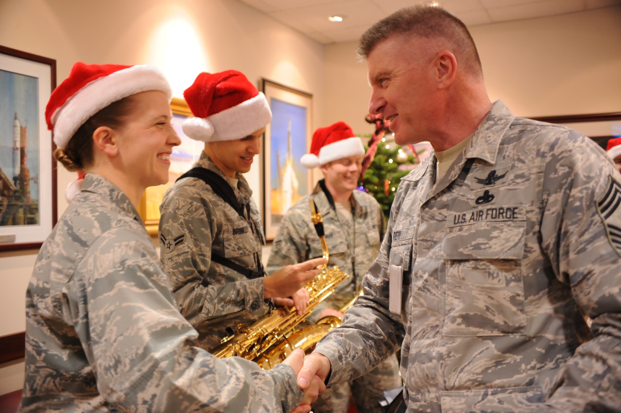 Space and Missile Systems Center Command Chief Master Sgt. Mark Repp gives a warm welcome to saxophone players from the U.S. Air Force Band of the Golden West, based at Travis Air Force Base, Calif., during their visit to entertain members at Los Angeles Air Force base, El Segundo, Calif., Dec.  9, 2011.
(U.S. Air Force photo by Sarah Corrice/Released)