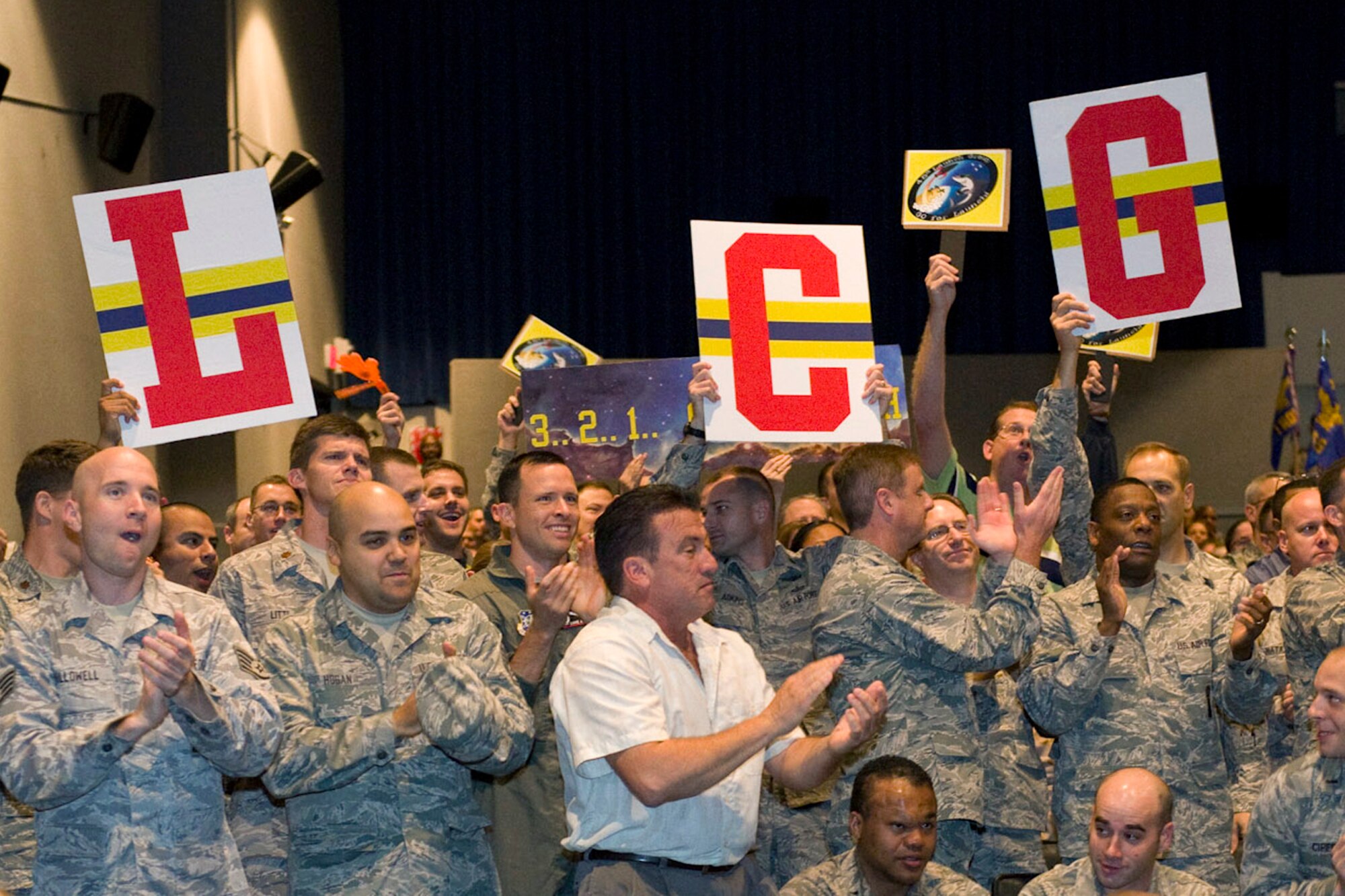 Members of the 45th Launch Group celebrate the culmination of 10 days of Consolidated Unit Inspection during a CUI Out Brief Dec. 15 at the Patrick AFB Theater. (U.S. Air Force photo/Julie Dayringer)