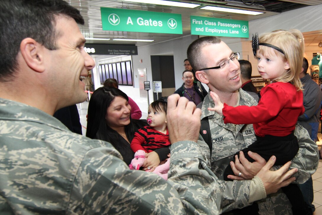 Col. Albert V. Lupenski, 932nd Airlift Wing commander, meets Lisette, daughter of Staff Sgt. Jason Becker.  Becker was one of several 932nd Civil Engineer Squadron members that returned from overseas deployment on Dec. 16.   (U.S. Air Force photo/ Tech. Sgt. Christopher Parr)